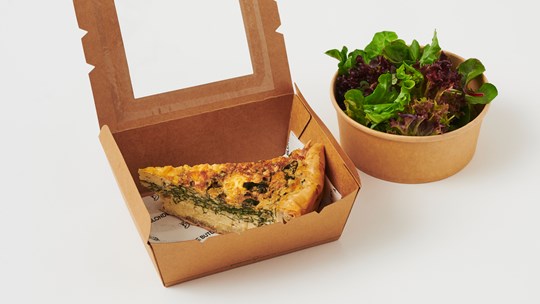 Individual slice of quiche with side salad
