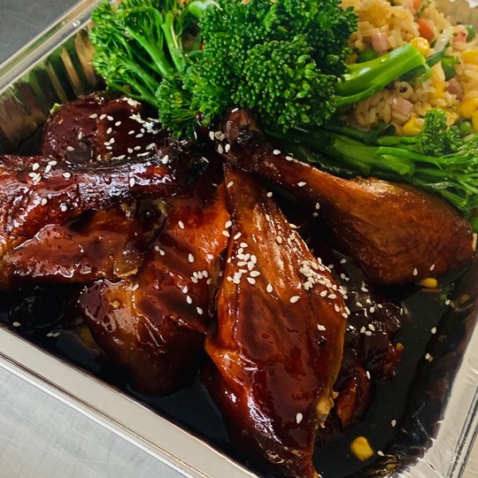 Honey soy and sesame glazed duck with fried rice and broccolini